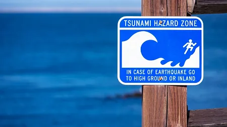 tsunami warning sign posted near the ocean