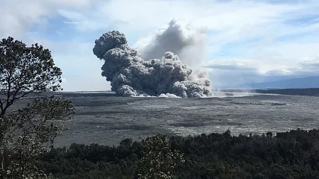 a gray column of smoke from a volcano