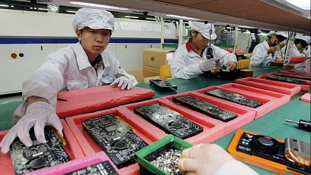 workers dressed in white manufacturing cell phones
