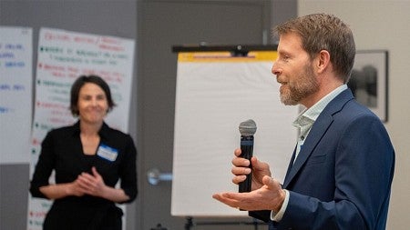 Dean Chris Poulsen speaking to an audience in a classroom
