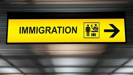 A yellow sign that says immigration