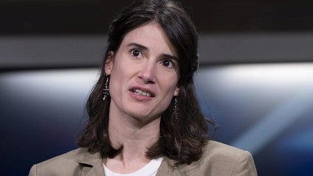 a congressional candidate speaks at a podium