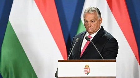 Hungarian Prime Minister Viktor Orban speaks at a podium