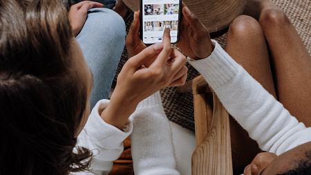 a person using a smartphone with another person 