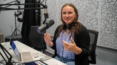 a student speaks into a microphone