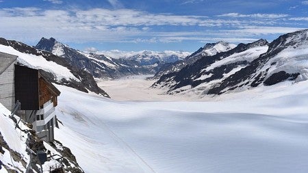 a snowy valley with blue skies