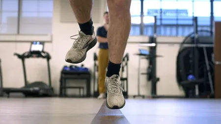 a person jumping with the frame showing their lower legs and running shoes