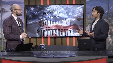 two people talking at a TV news desk