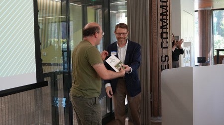 Man presenting an award to another person