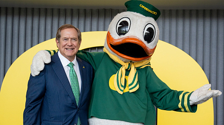 Jordan Schnitzer posing with the Oregon Duck mascot