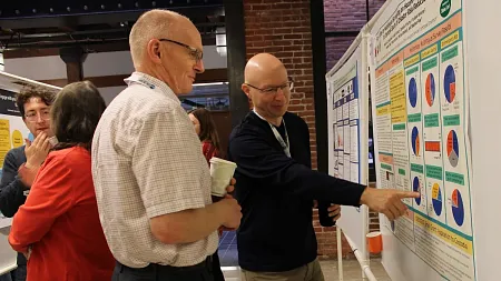 a photo of people looking at a poster