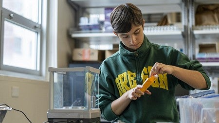 a person in a lab using seeds