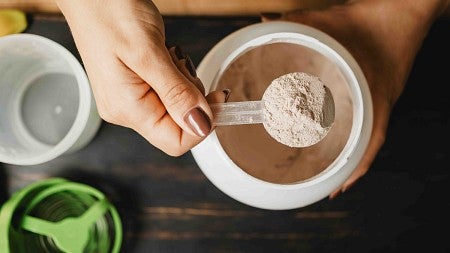 a person with a spoonful of protein