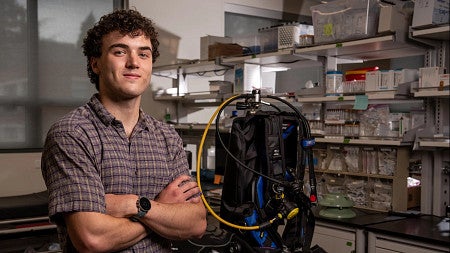 a person standing in a lab with scuba gear
