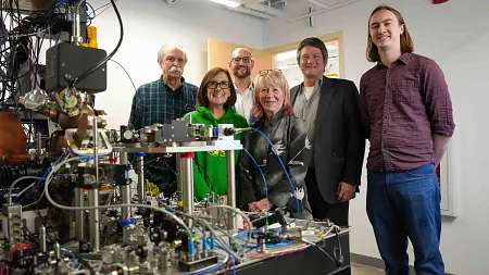 people standing next to a quantum computer