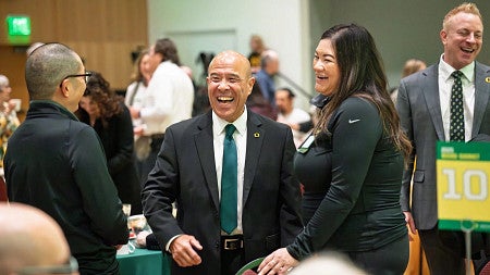 people gathered laughing at a meeting