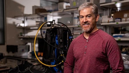 a headshot of a person standing in a lab