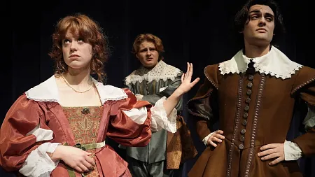 three people dressed in Shakespearean costumes