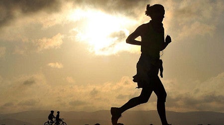 a person running at sunset