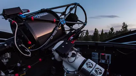 a telescope pointed toward the dusk sky