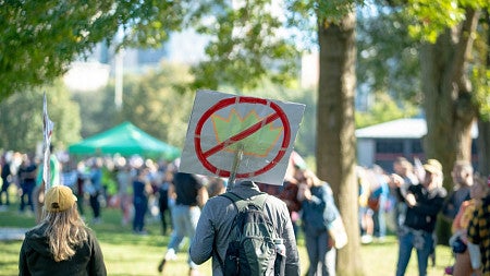 a person holding a sign at a protest