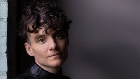 a person wearing in black poses for a photo