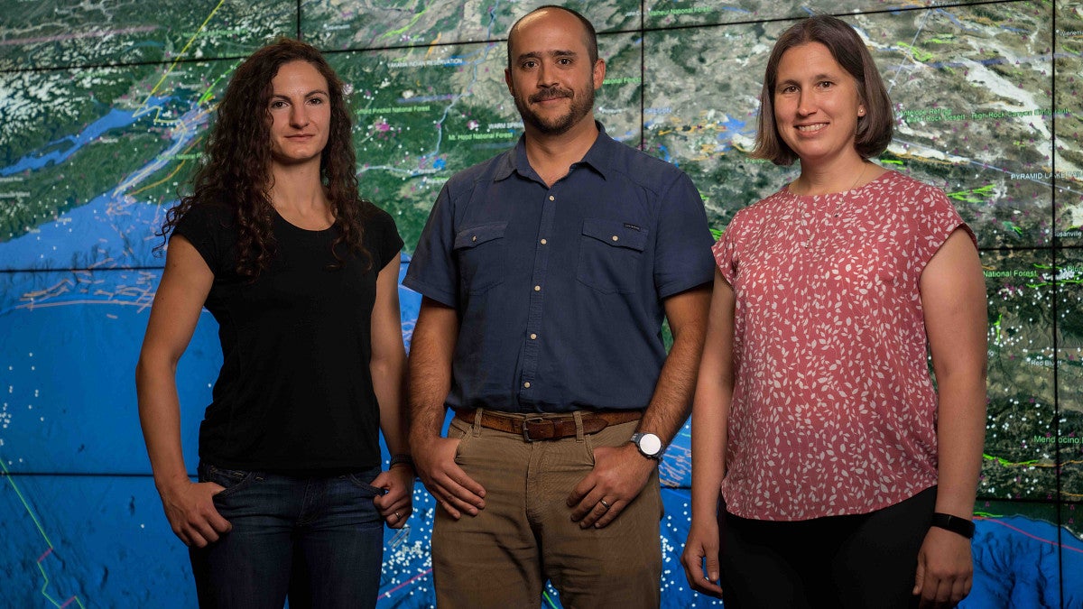 CRESCENT PIs pose in front of a map