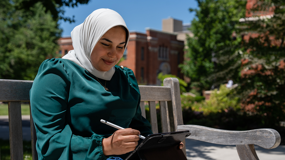 woman looking at tablet smiling