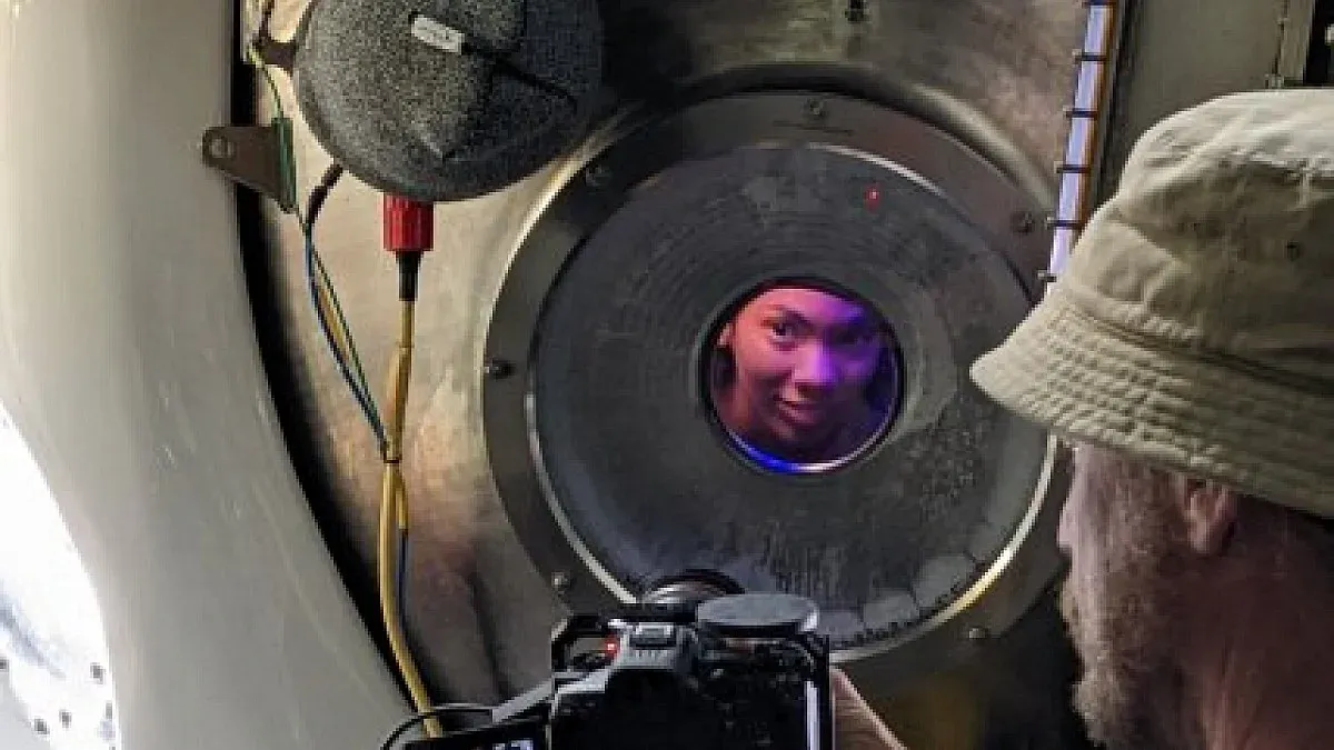 person peers through window