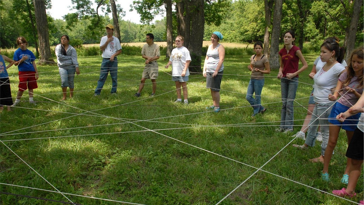 People standing in circle doing ritual