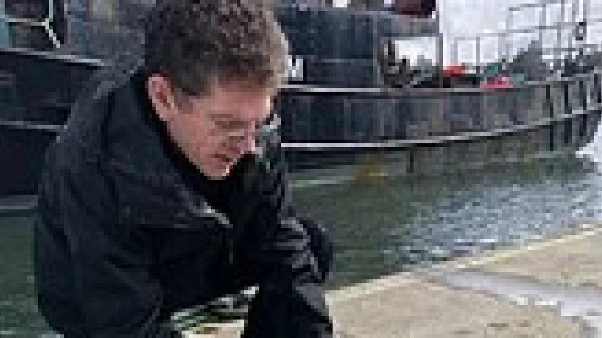 Marine researcher handling specimens on boat