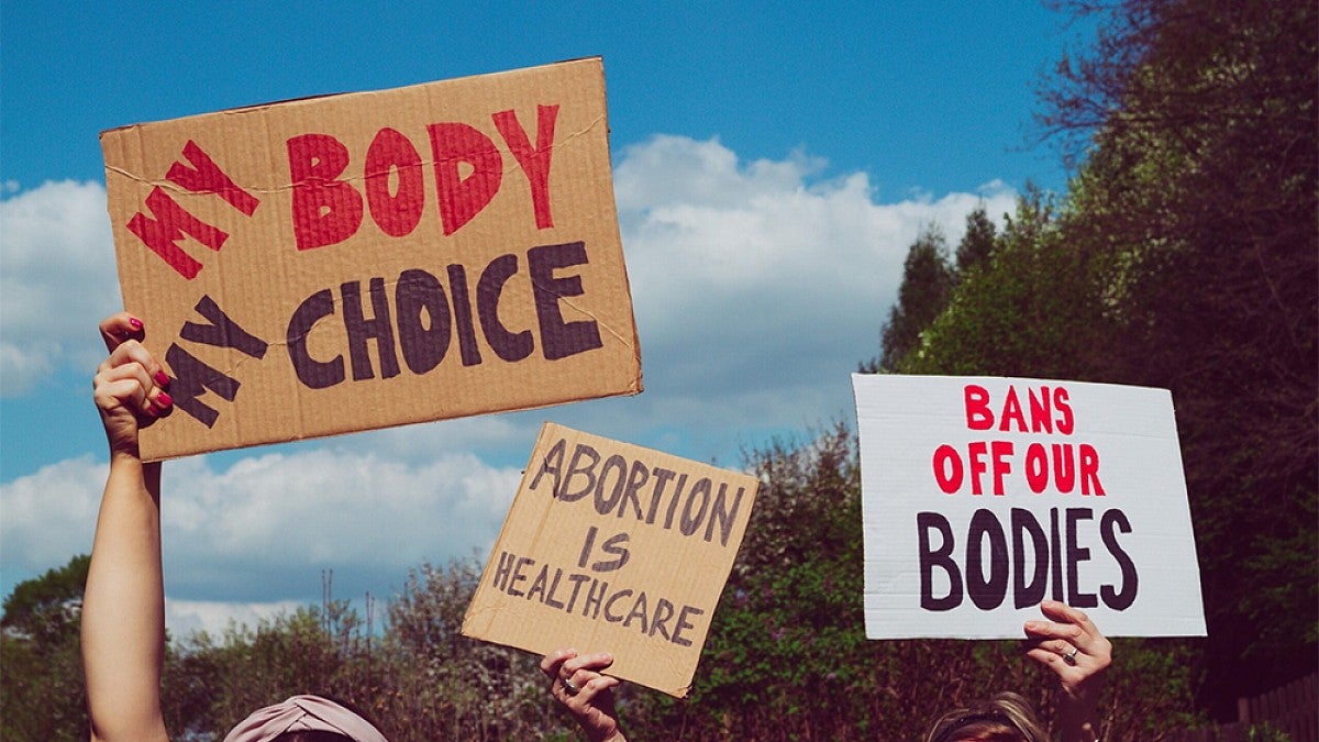 People holding up signs with slogans written on them