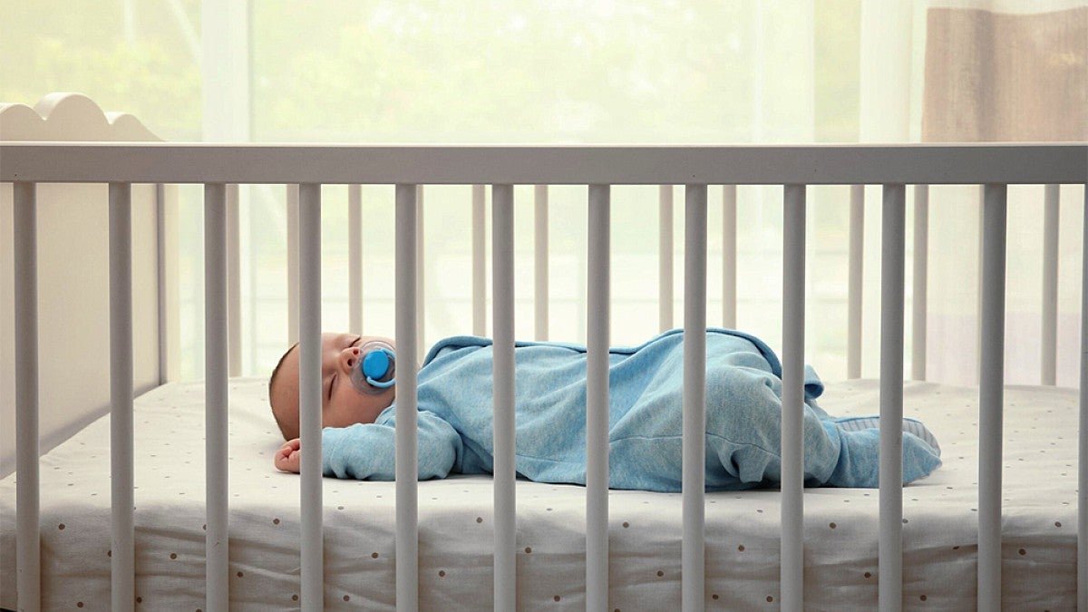 A baby sleeping in a crib