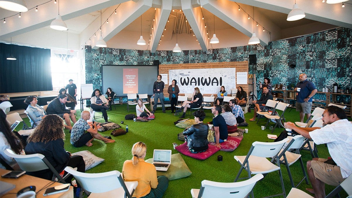 People gathered in a round room for AI conference
