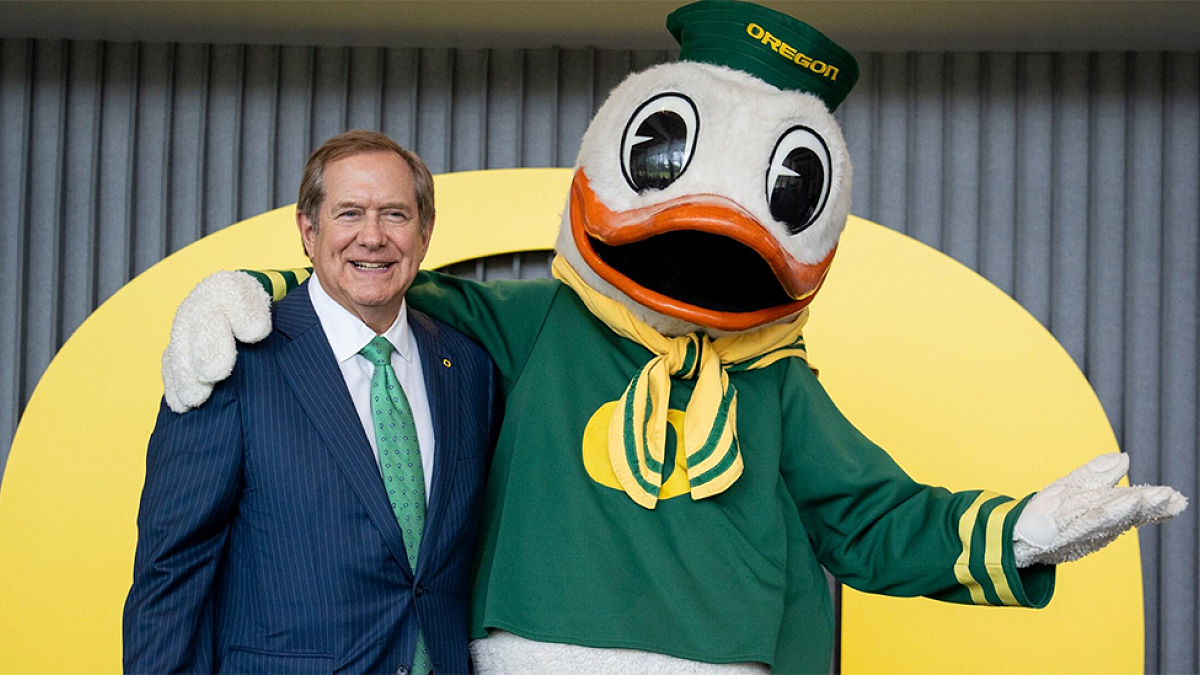 Jordan Schnitzer posing with the Oregon Duck mascot