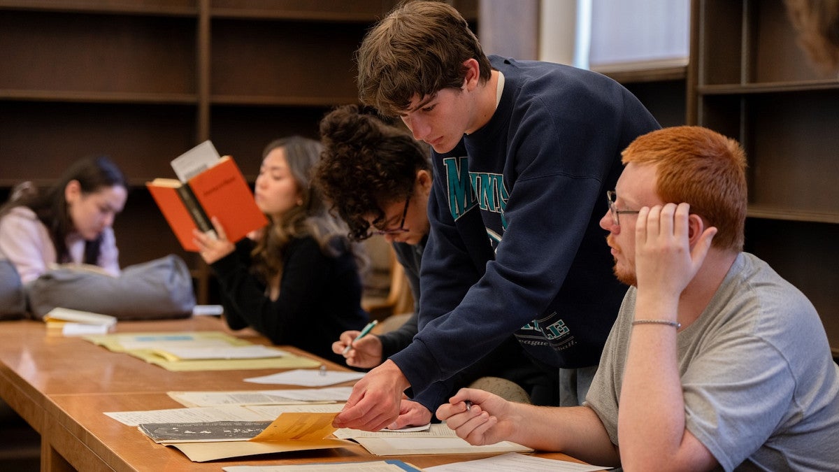 students in library review artifacts