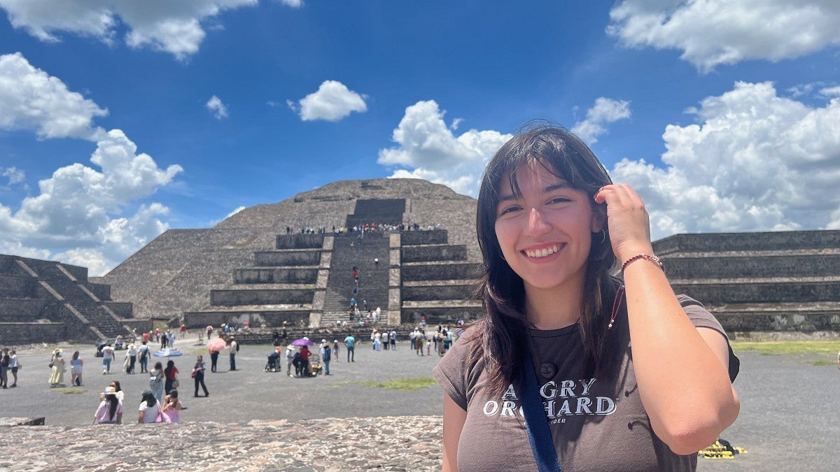 general social sciences major adri jolie standing in front of Chichén Itzá in mexico as part of her study abroad trip
