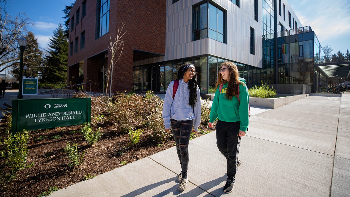 two students walking outside Tykeson Hall where CAS Academic Advising is located