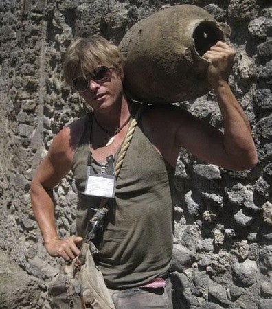Professor Kevin Dicus holding ancient pottery