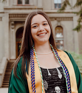 woman smiling in graduation regalia