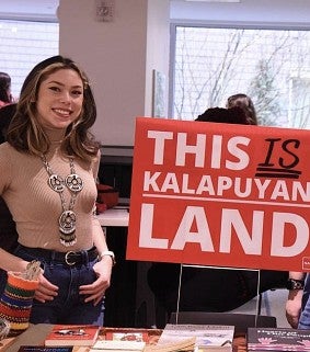 Students holding sign