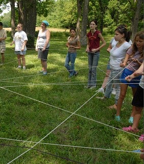 People standing in circle doing ritual