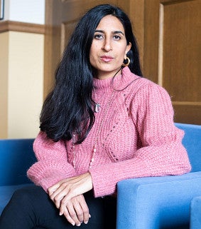 Anita Chari sitting on a blue couch