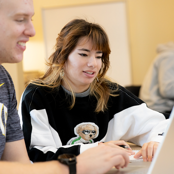 two people looking at computer